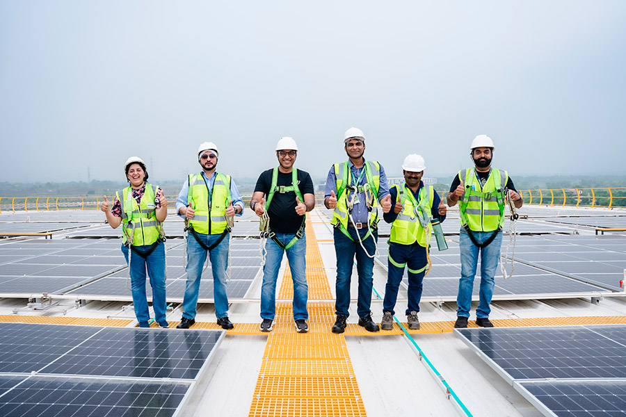 Solar EPC company team reviewing rooftop installation plans India